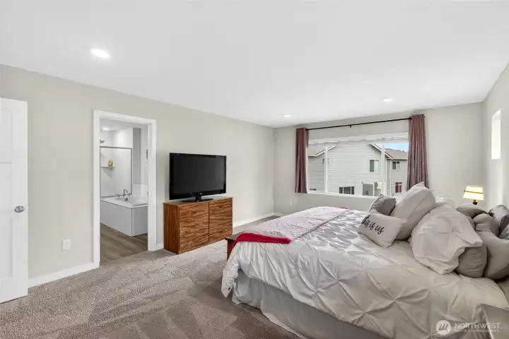 Spacious and private primary suite with attached 5 piece bath and large closet