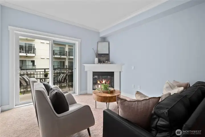 Spacious living room with 9' ceilings, cozy electric fireplace, and slider out onto the balcony. Spacious living room with 9' ceilings, cozy electric fireplace, and slider out onto the balcony.