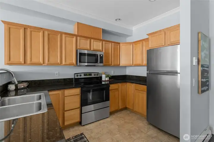Kitchen offers lots of cabinetry, granite countertops and a brand new stove & microwave and newer refrigerator & dishwasher. Kitchen offers lots of cabinetry, granite countertops and a brand new stove & microwave and newer refrigerator & dishwasher.