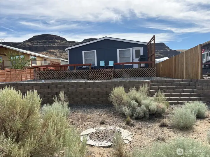 Back of the home showing stairs leading to the river