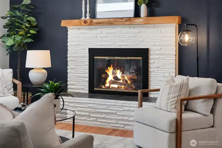 A cozy fireplace creates a warm and inviting gathering space, perfect for relaxing on crisp Pacific Northwest evenings.