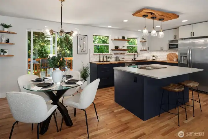 The spacious kitchen island with cooktop creates the perfect gathering place for preparing meals, sharing a glass of wine, and enjoying conversation with family and friends.