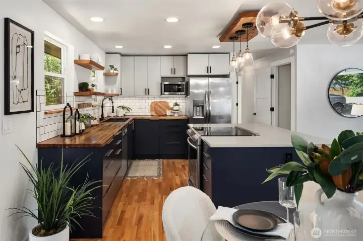 Warm wood countertops add natural character and timeless Pacific Northwest style to the kitchen.