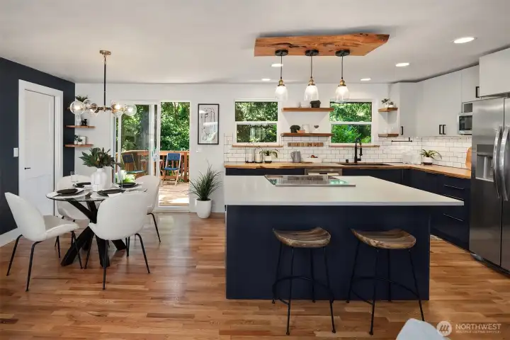 Modern finishes paired with natural design elements create a warm, inviting kitchen that overlooks the expansive double-parcel property, seamlessly blending indoor comfort with the beauty of the Pacific Northwest landscape.