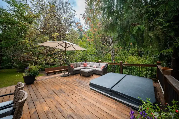The large deck really expands the living area of this home. Imagine a hot tub soak in this beautiful setting at sunset with a glass of wine The large deck really expands the living area of this home. Imagine a hot tub soak in this beautiful setting at sunset with a glass of wine