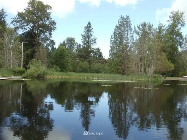 View of lake frontage on the east side of the dock with eastern property boundary in the background.