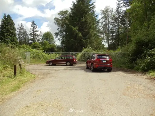 The property is to the left and on the other side of the fence line at the south end of 14th Ave SE.