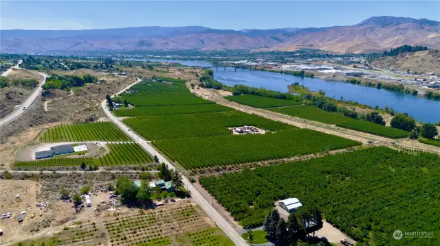 Prime home and ranch territory.  Presenting nearly 27 acres of cherry orchard, ranch house and tons of options for expansion making a great Agri-investment just up river from Wenatchee at desirable Baker Flats subarea.  This photo from over the grounds looking south toward Wenatchee and the Columbia river for reference