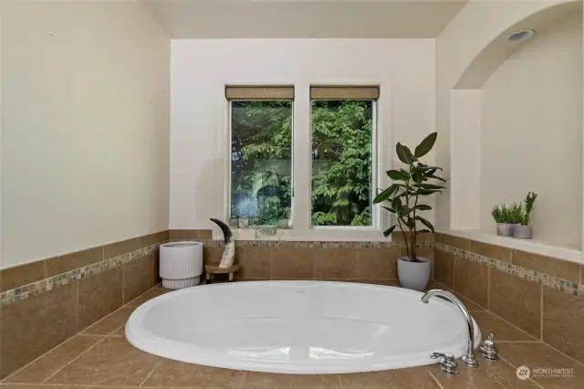 Ultimate relaxation awaits in this amazing soaking tub. This generous size soaking tub invites you to unwind and rejuvenate. Situated beneath double windows that overlook the outdoors this luxurious tub provides a tranquil escape.