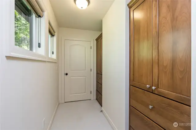 This area is located inside the primary bedroom and offers two built in storage areas. This hallway leads to the extra finished room located inside the primary bedroom.