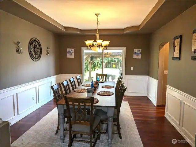 Coffered ceiling, wainscoting, hardwoods, access to back yard w/patio & gazebo directly behind.