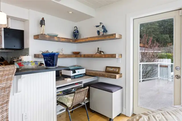 A mini office is a part of this home and is a great space to stay neat and organized. The door to the right leads out to an expansive deck for easy outdoor entertaining/barbecuing.