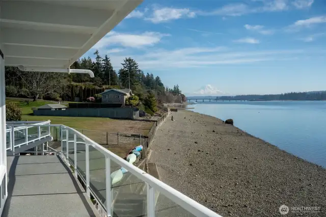 The deck expands across the front of this home and to a larger entertaining/viewing area. 52 feet of gorgeous beach belongs to this home