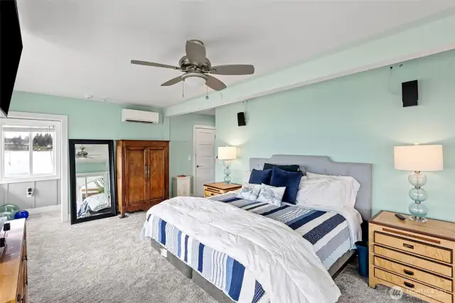 Another view of the primary bedroom with refreshed carpet and ceiling fan.  This home includes ductless heating and air conditioning on each level.