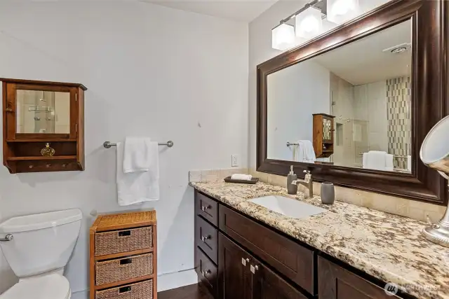 The primary bath includes a beautiful vanity with granite countertops and no-edge sink.