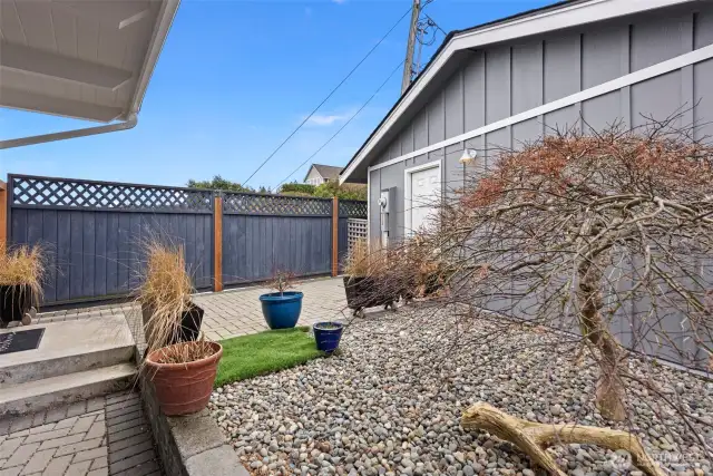 This is the yard in between the 2-car garage and the entrance to the home. There is plenty of room to add your own touches with planters, flowers, etc.