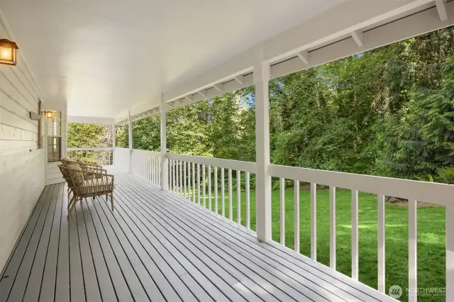 Fresh paint throughout the expansive covered deck overlooking the sunny lawn