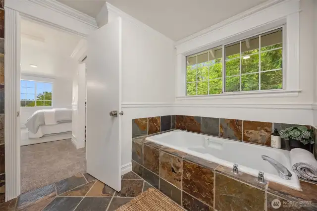 Primary suite soaking tub across from the walk-in shower