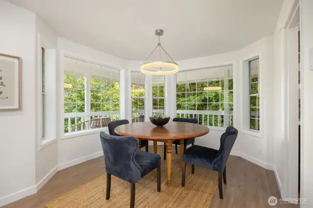 Enjoy this cozy dining room surrounded by windows with easy service from the adjacent kitchen