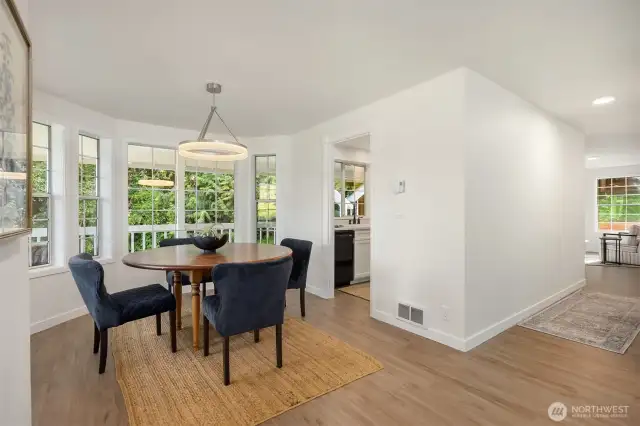 The main floor emphasizes communal space and offers easy access outside, to the attached 2-car garage, and to the upper and lower levels