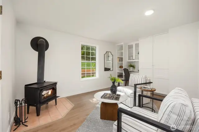 Built-in storage and a convenient desk space compliment the cozy wood stove