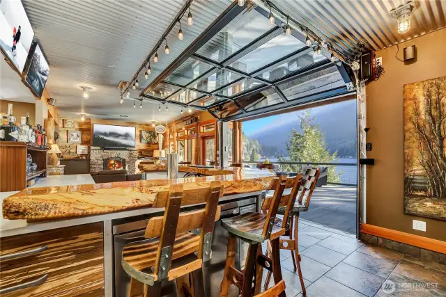 A view of the live edge bar and roll up garage door to the patio.