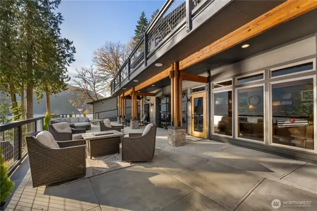 Another patio view with wrap around deck above.