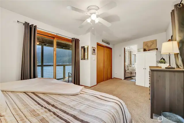 A very large bedroom with lake views.
