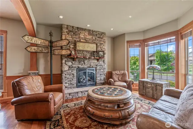One of four stately fireplaces...enjoy this spacious front living room off the entrance - a perfect place to sit w/guests!