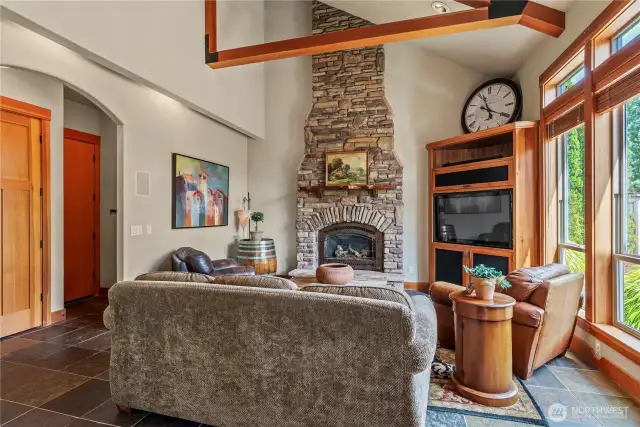 Great room with wood beam detail, soaring ceilings & Fireplace Xtrordinaire!