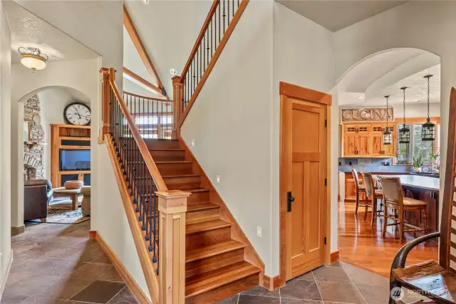 Wood trim, doors, stairs, arched entrances lead to each room.