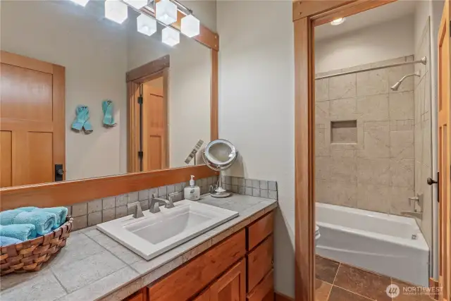 Full main bath with comfort height cabinetry & tiled in tub surround....