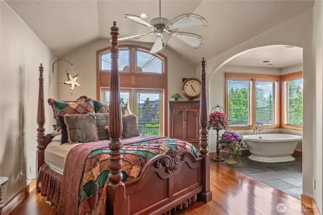 Arched details continue on the second floor in this grand suite! Soaking tub with a view!