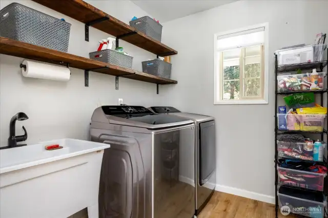 Laundry room with open shelving.