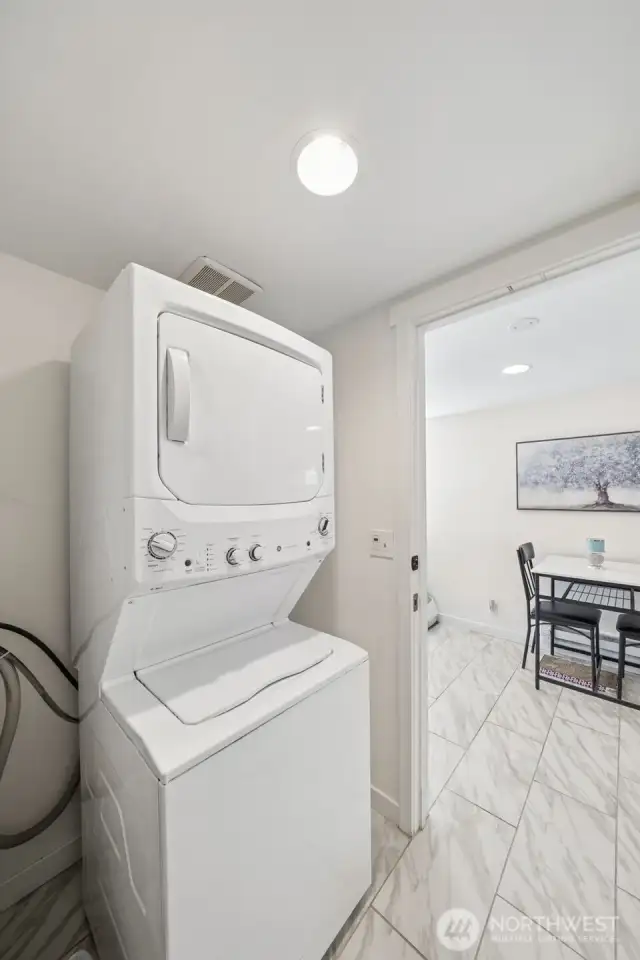 Take the stairs down to the deluxe suite. The laundry room is in the stairwell connecting the upstairs and the basement.