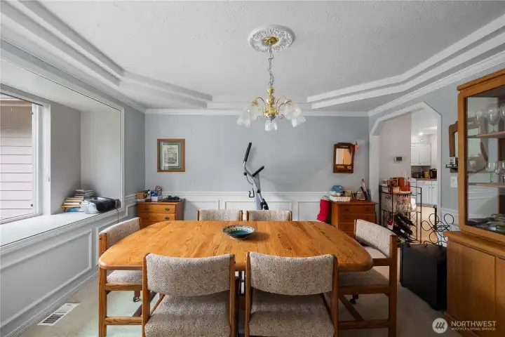 Coved ceilings and wainscoting in the formal dining room, plus a sweet bench.