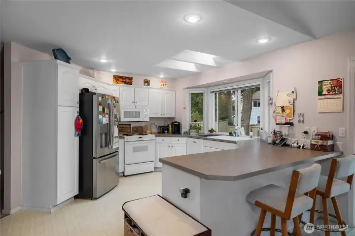 Vaulted ceiling and skylights in the kitchen. Large window for keeping an eye on the backyard.