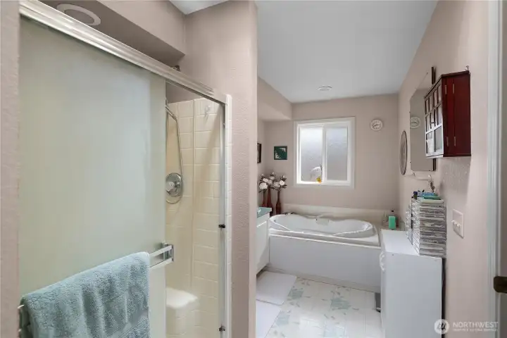 Primary bathroom offers deep soaking tub, shower and double sinks.