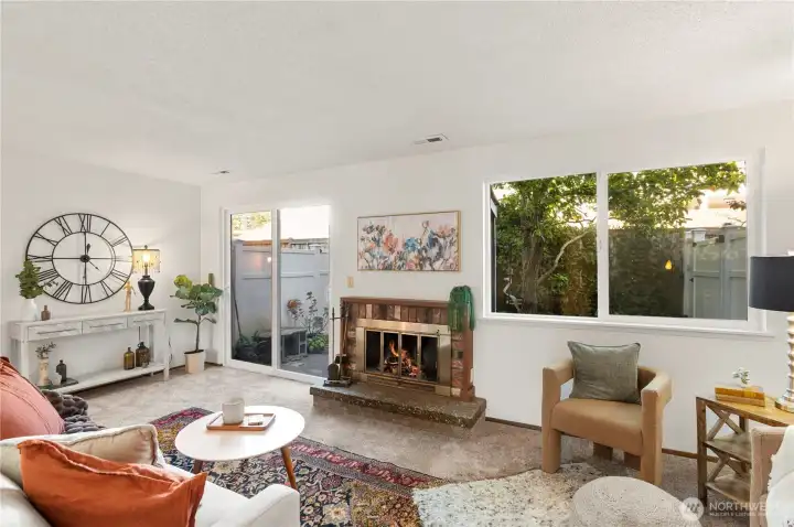 Cozy up around the fireplace and enjoy the view of your garden.