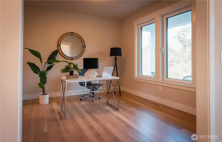 This versatile flex space offers the perfect blend of function and comfort, ideal for today’s dynamic lifestyle. Bathed in natural light from a large window, the room feels bright and inviting, highlighting the warm wood flooring and clean, neutral palette. Currently set up as a combination home office, it easily adapts to your needs—whether you envision a productive workspace, workout room, hobby studio, or even a formal living or dining area. Thoughtfully arranged with ample open floor space, this room showcases just how effortlessly it can support multiple uses while maintaining a sense of calm and organization.