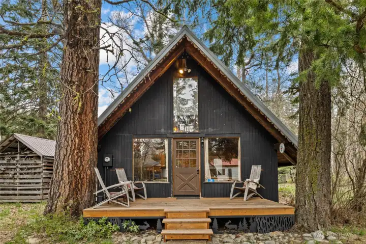 Classic A-frame silhouette nestled among mature evergreens.