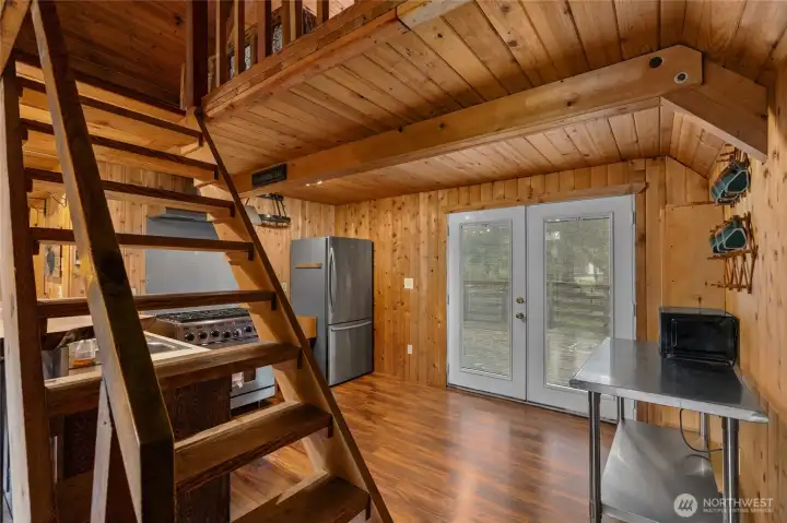 Cabin kitchen with timeless appeal. French doors lead to the deck for seamless indoor-outdoor living.