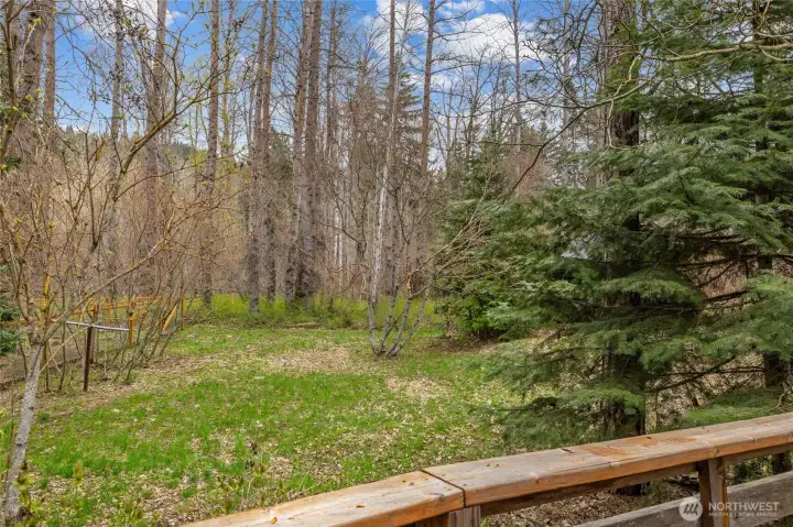 Deck overlooks peaceful, wooded surroundings.
