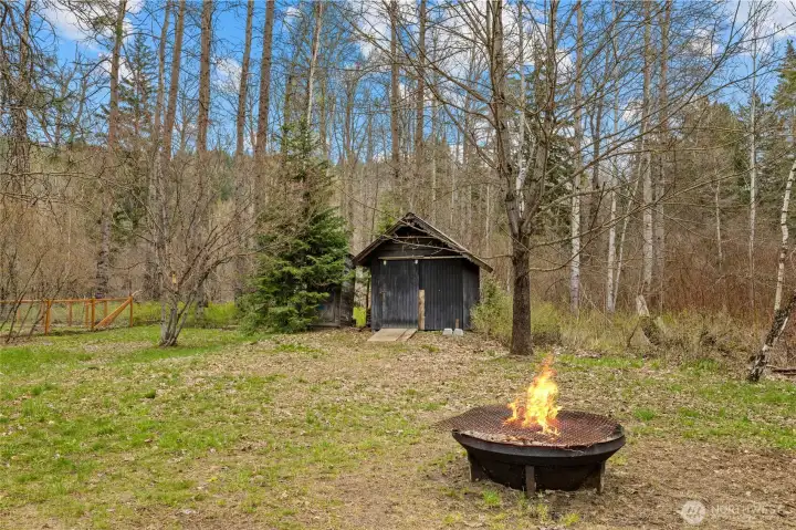 Rustic shed adds to the property’s charm. Firepit area ready for evenings under the stars.