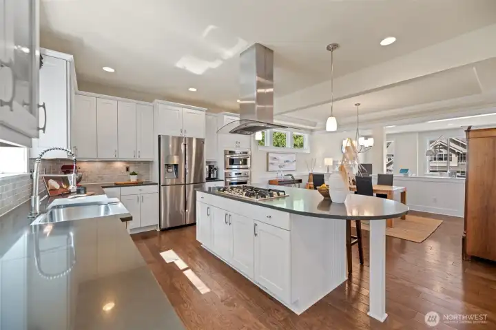 Chef's kitchen featuring Stainless Steel appliances, 5-burner gas cooktop, double-oven and microwave.