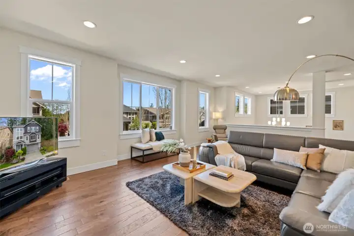Note the rich hardwood flooring throughout, the high ceilings and oversized windows for more natural light.