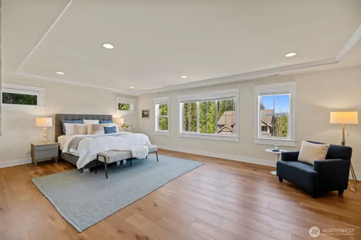 Primary bedroom retreat, upgraded with hardwood flooring.