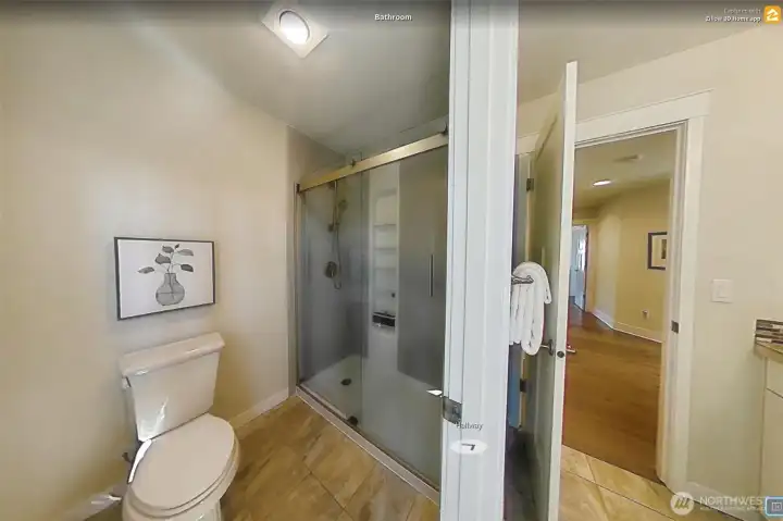 Sleek lines for this shower with glass doors, upgraded by sellers.