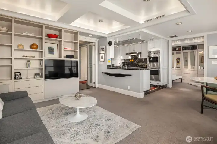 Exquisite trim work with coffered ceilings, 5"base, durable berber carpet, custom builtins and expansive home theater system with surround sound