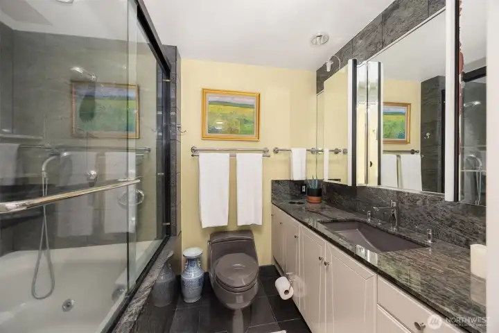 Primary bedroom ensuite with dual shower and large jacuzzi soaking tub.